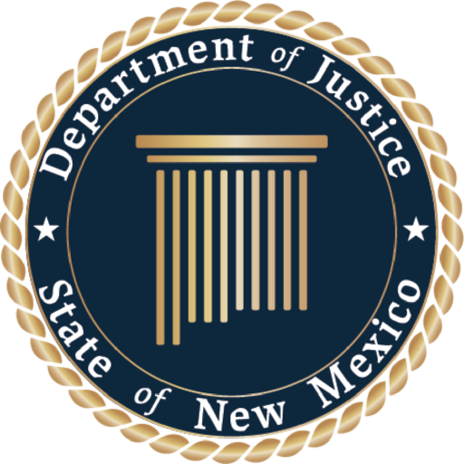 The image is of the New Mexico Department of Justice's secondary seal. The seal is framed with gold gradient rope and a slim gold bar followed by a thicker dark blue circular bar that has white text that reads, "State of New Mexico" at the bottom and "Department of Justice" at the top. Another slim circular gold bar is featured before the center of the seal. The Center of the seal is a dark-blue circle with a gold, gradient version of the roman-inspired Pillar in the shape of New Mexico.